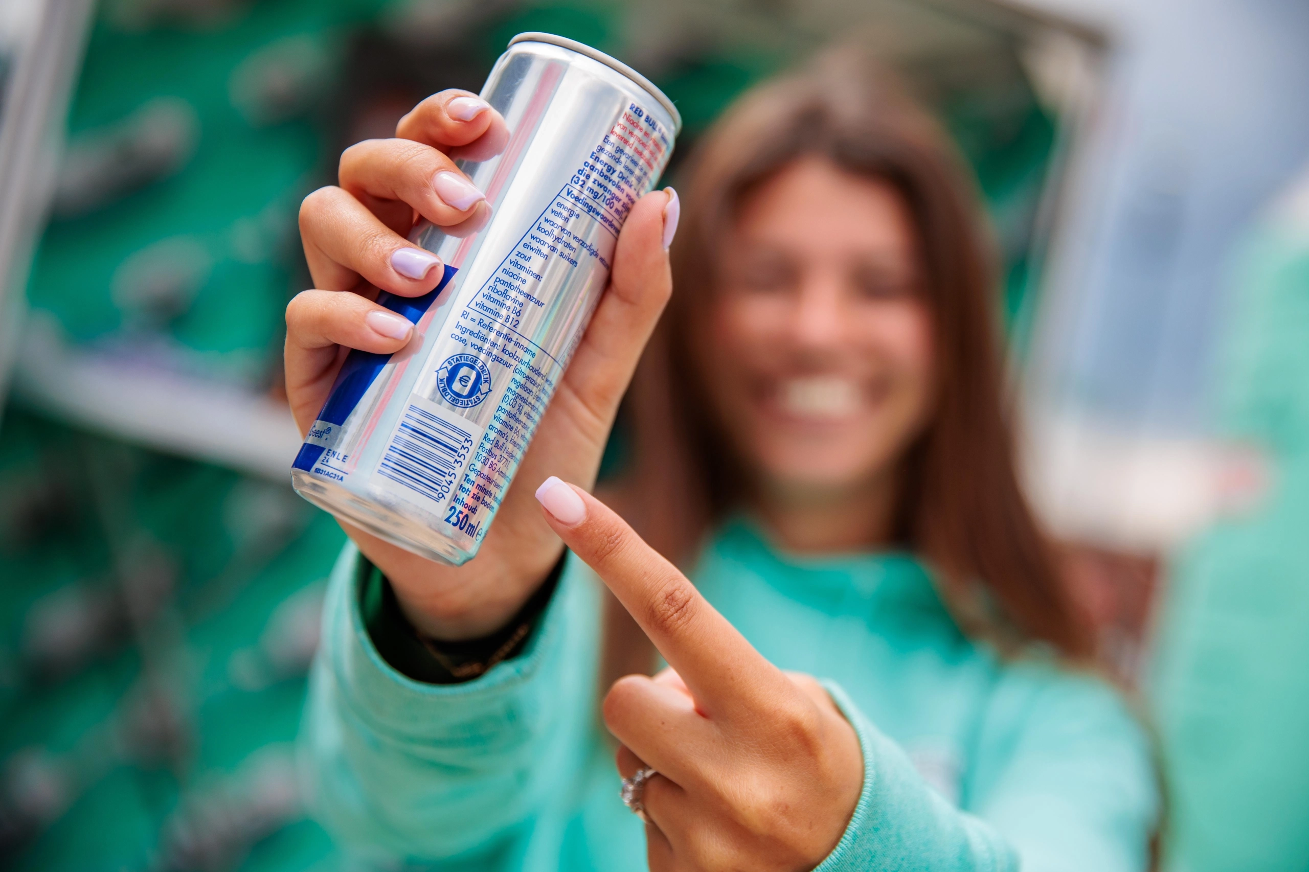 Meisje heeft een statiegeldblikje vast en wijst naar het statiegeldlogo